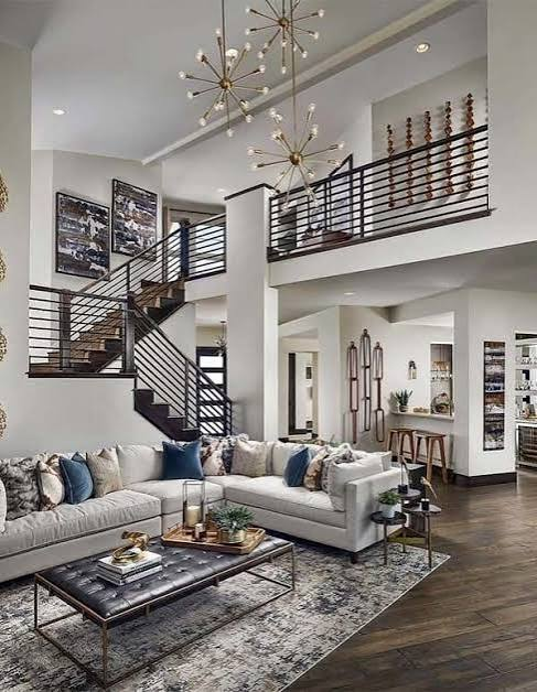 Elegant living room with high ceilings, modern chandelier, and neutral tones